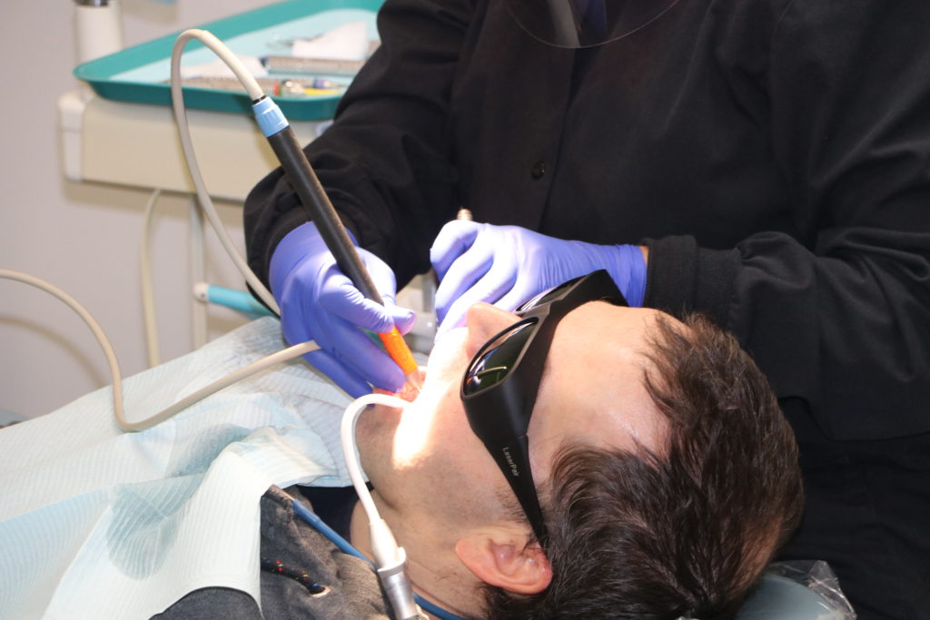 male patient does a dental cleaning