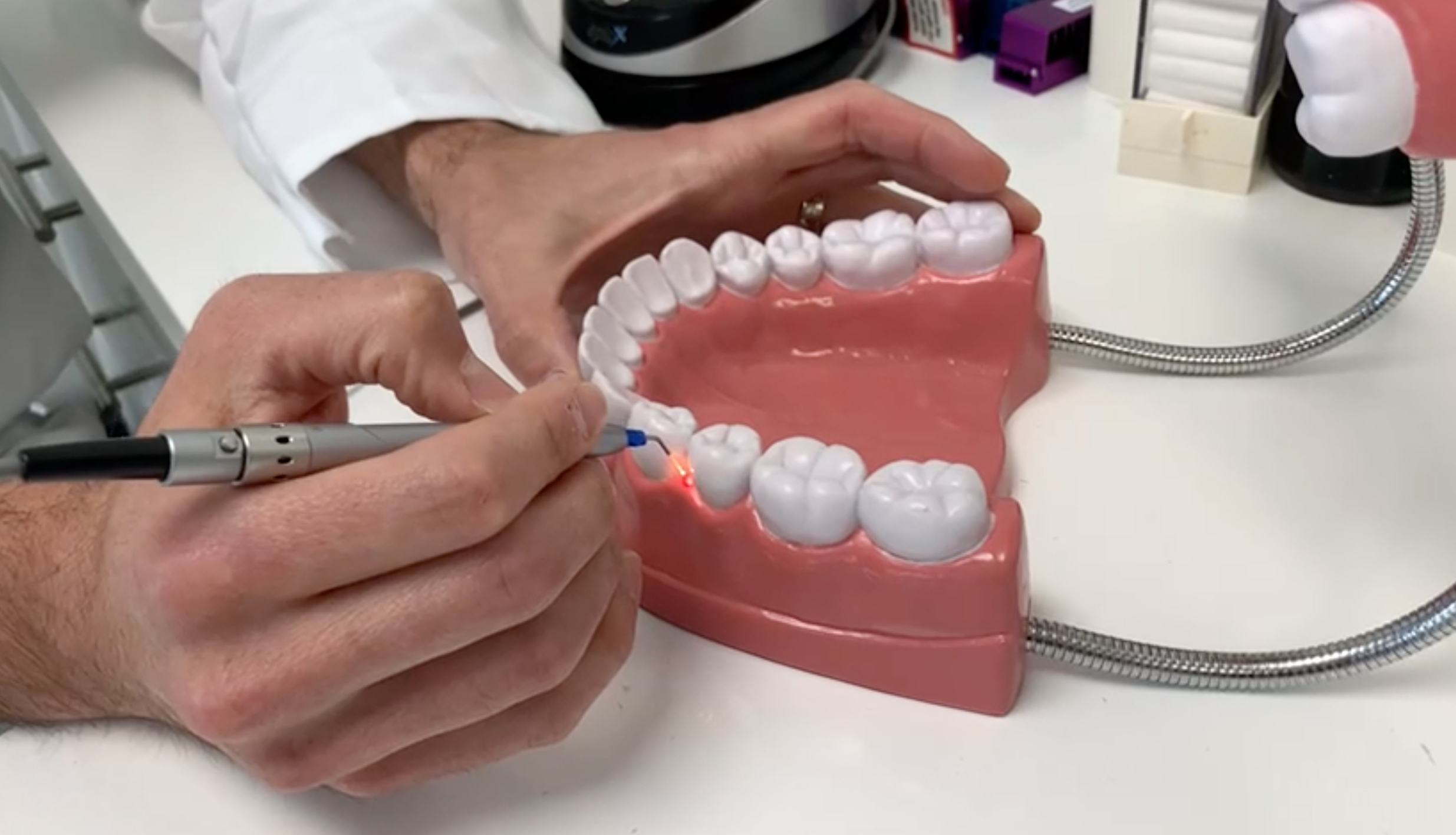 dentist shows the process of LBR therapy